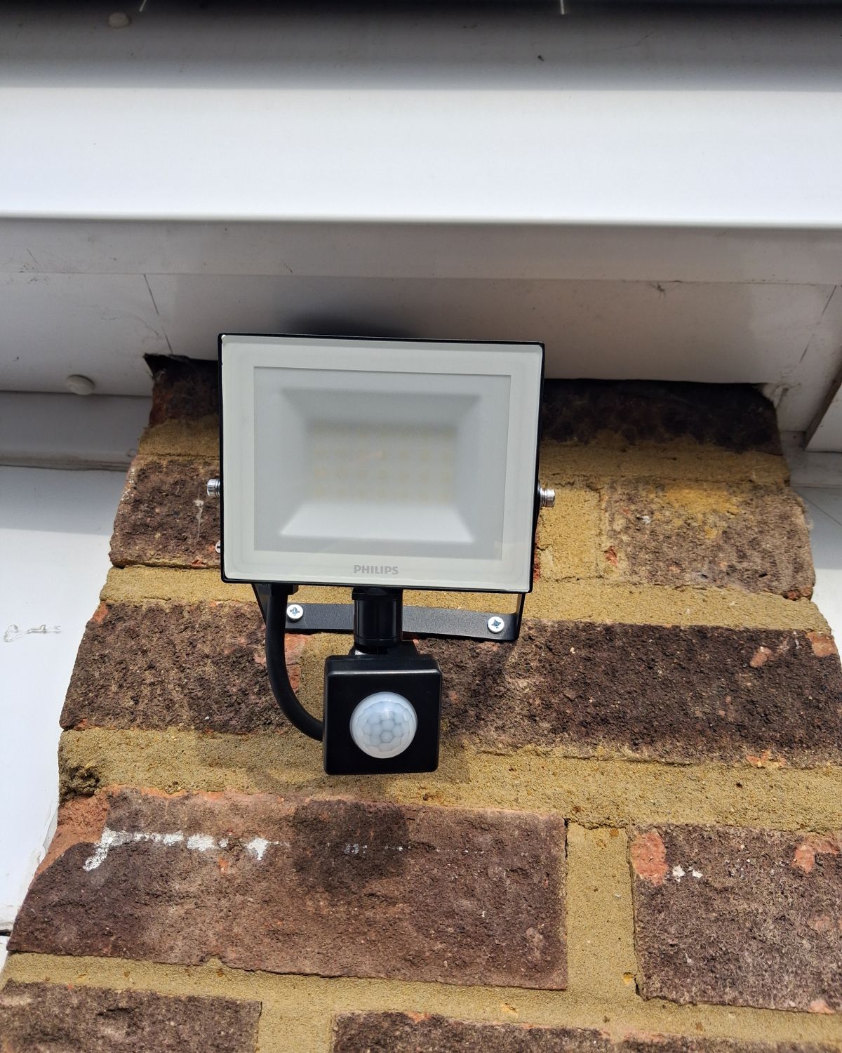 After: a new PIR security floodlight fitted neatly under the eaves
